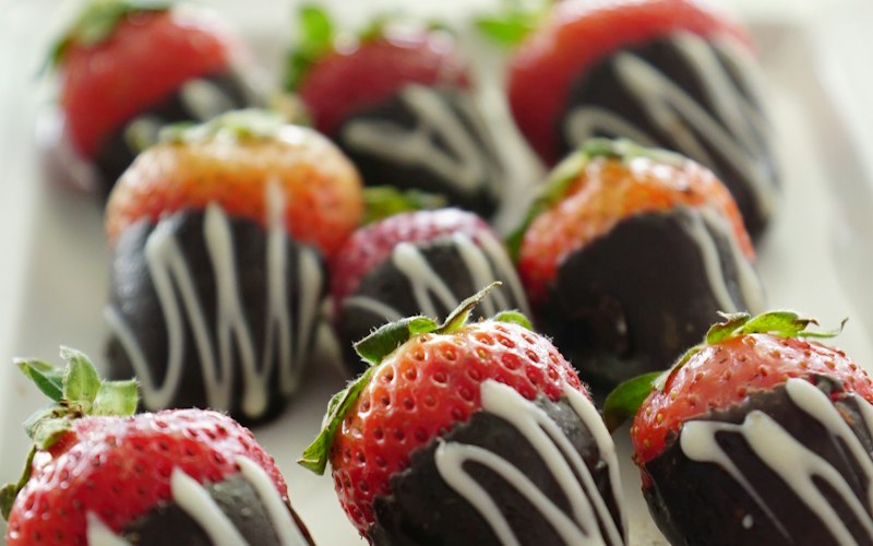 Chocolate covered strawberries arranged on a plate